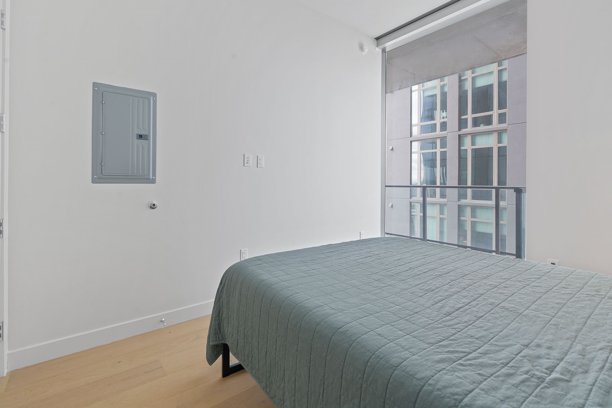 44 East Avenue, Unit 1902 Austin, TX 78701 - Photo 14 of 40 a bedroom with a bed and glass door