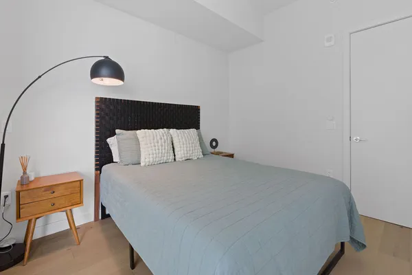 a bedroom with a bed and window