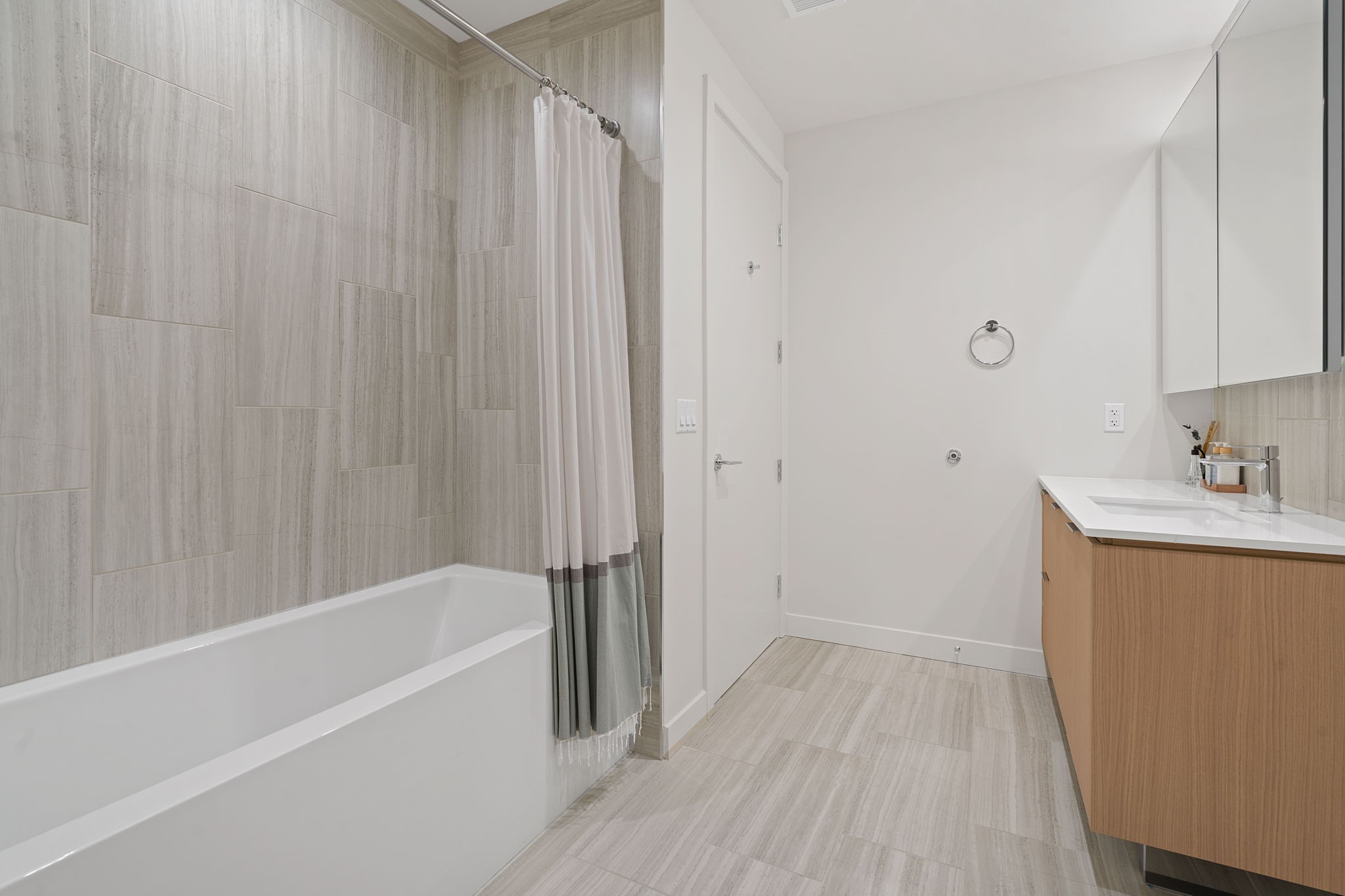 44 East Avenue, Unit 1902 Austin, TX 78701 - Photo 20 of 40 a bathroom with a bathtub a sink and a shower
