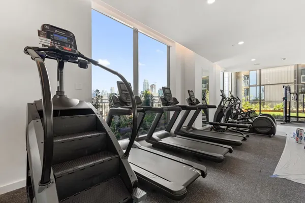 a living room with couches and a large window with balcony view