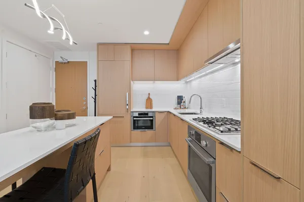 a kitchen with a sink a stove and cabinets
