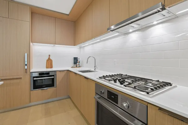 a kitchen with granite countertop a stove and a sink