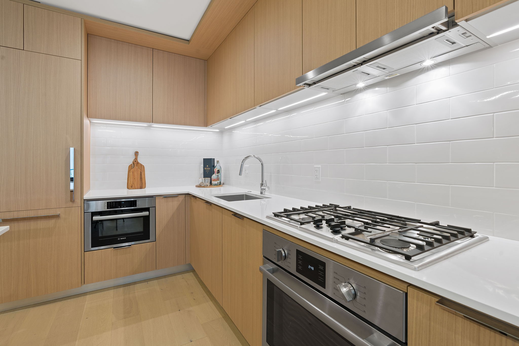 44 East Avenue, Unit 1902 Austin, TX 78701 - Photo 6 of 40 a kitchen with granite countertop a stove and a sink