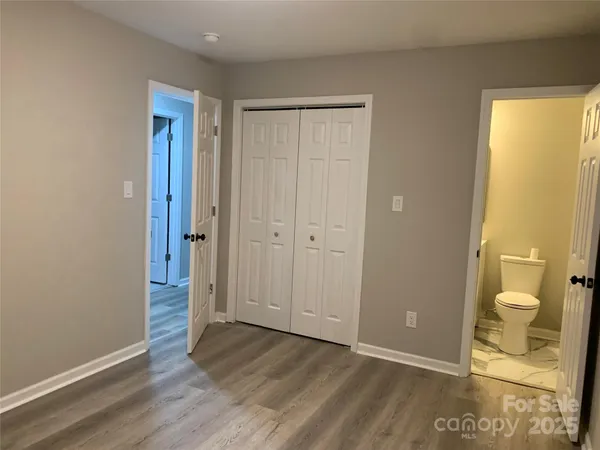 a view of a bathroom with wooden floor