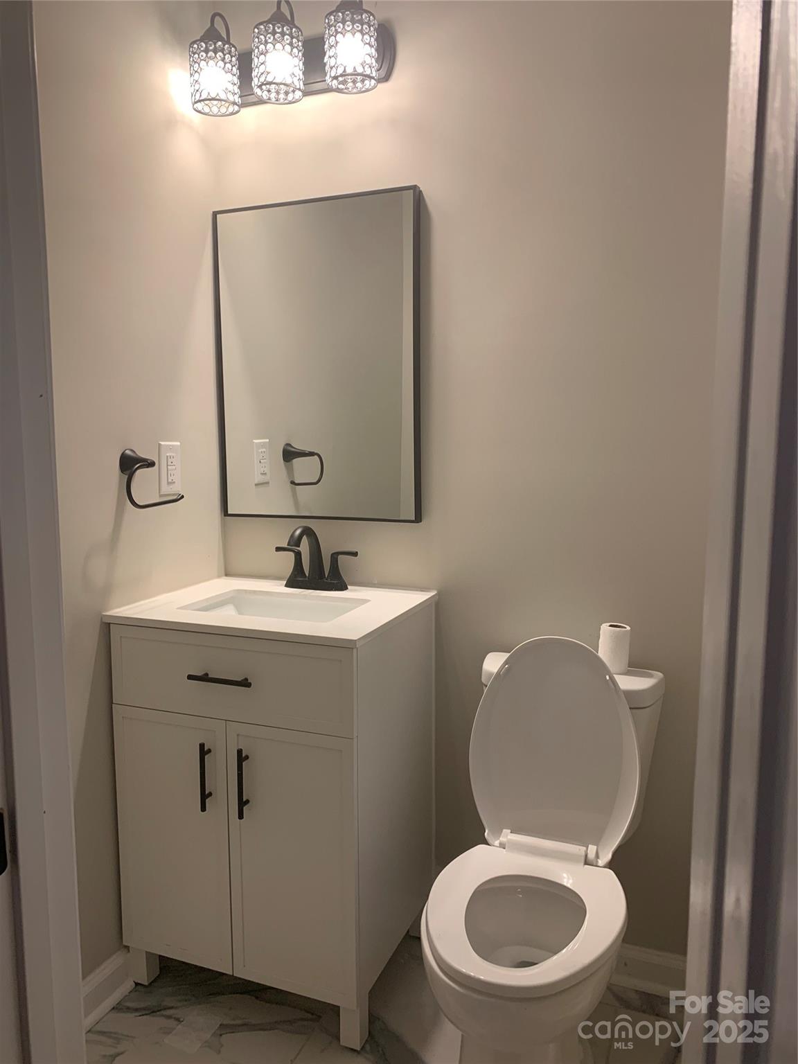 501 Colony Road Monroe, NC 28112 - Photo 13 of 14 a white toilet sitting next to a bathroom sink
