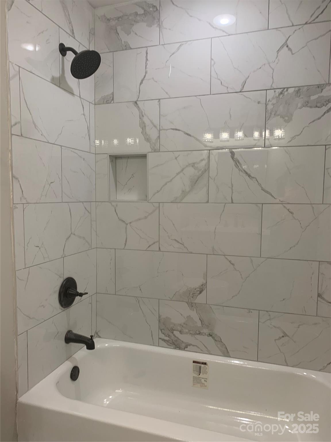 501 Colony Road Monroe, NC 28112 - Photo 9 of 14 a bathroom with a white bath tub and a shower