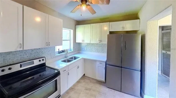 a kitchen with a refrigerator and a sink