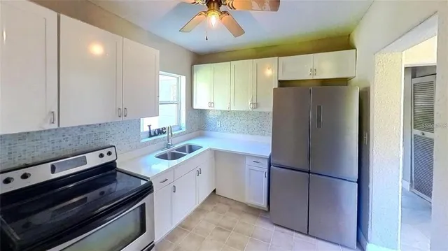 a kitchen with a refrigerator and a sink