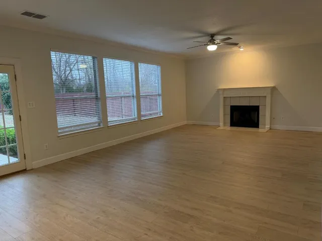a kitchen with a sink a stove a refrigerator and white cabinets