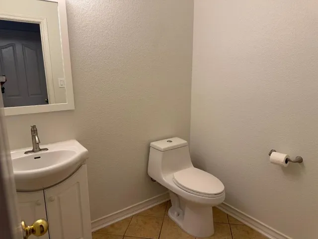 a view of hallway with stairs and a chandelier