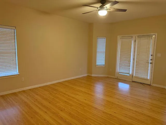 a view of balcony with wooden floor and fence