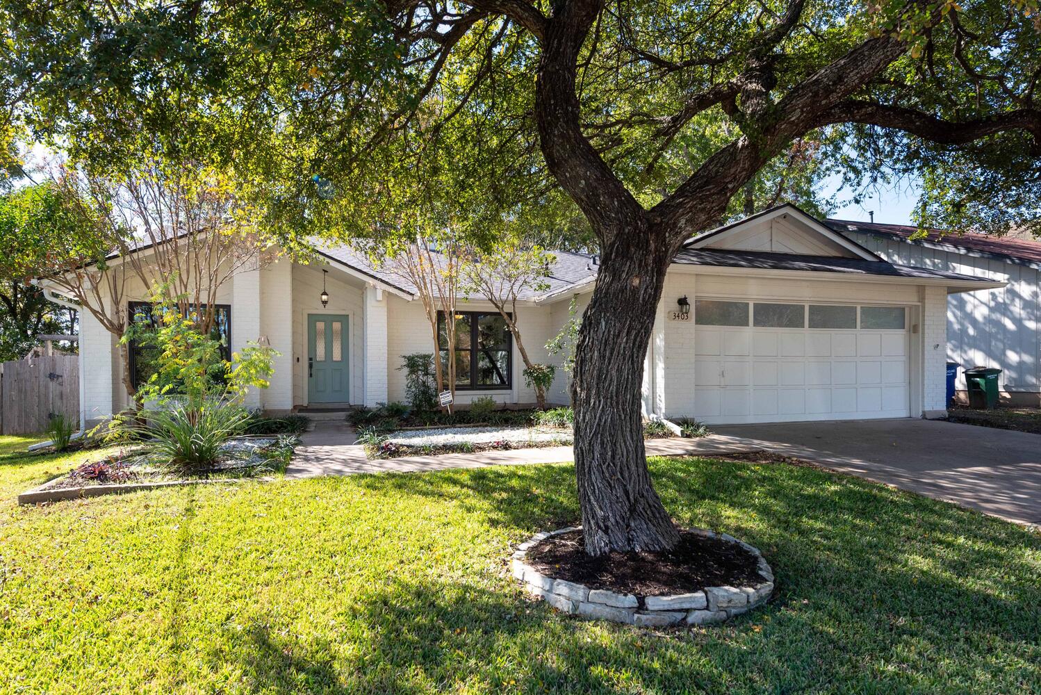 3403 Palomar Lane Austin, TX 78727 - Photo 2 of 33 Ranch-style house with brick siding, concrete driveway, and a front lawn