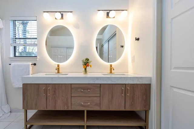 a room with two mirror and a wooden floor