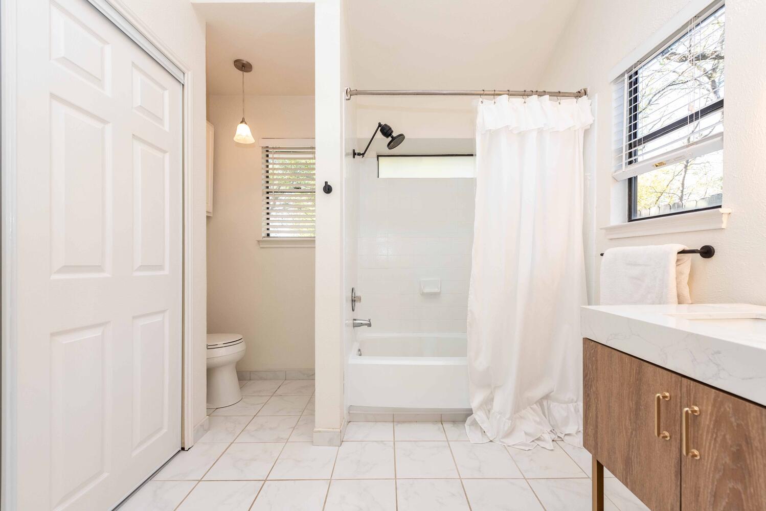 3403 Palomar Lane Austin, TX 78727 - Photo 24 of 33 Bathroom with shower / tub combo with curtain, vanity, and light tile patterned floors
