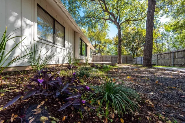a view of a house with a small yard and potted plant