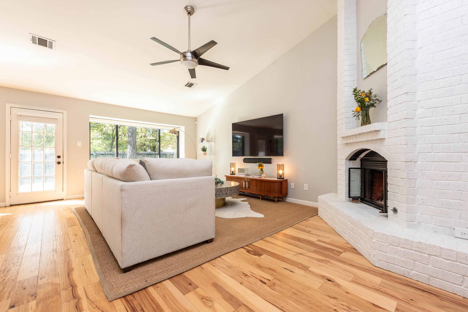 3403 Palomar Lane Austin, TX 78727 - Photo 6 of 33 Living area featuring light wood-type flooring, a fireplace, high vaulted ceiling, and a ceiling fan