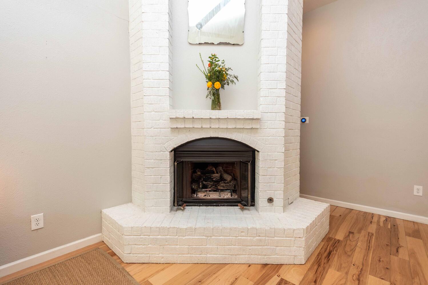 3403 Palomar Lane Austin, TX 78727 - Photo 9 of 33 Detailed view of a brick fireplace and wood finished floors