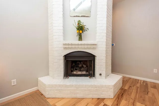 a living room with a fireplace and a rug