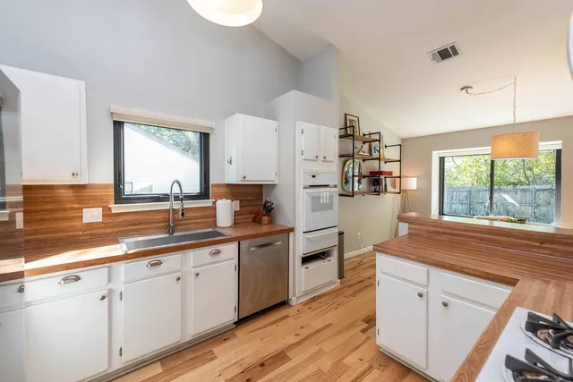 a kitchen with cabinets and window