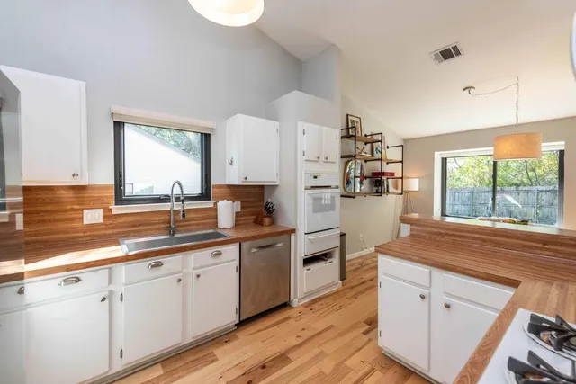 a kitchen with cabinets and window