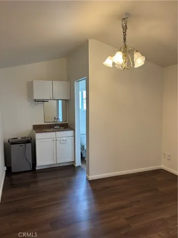 a view of kitchen with stove refrigerator and microwave