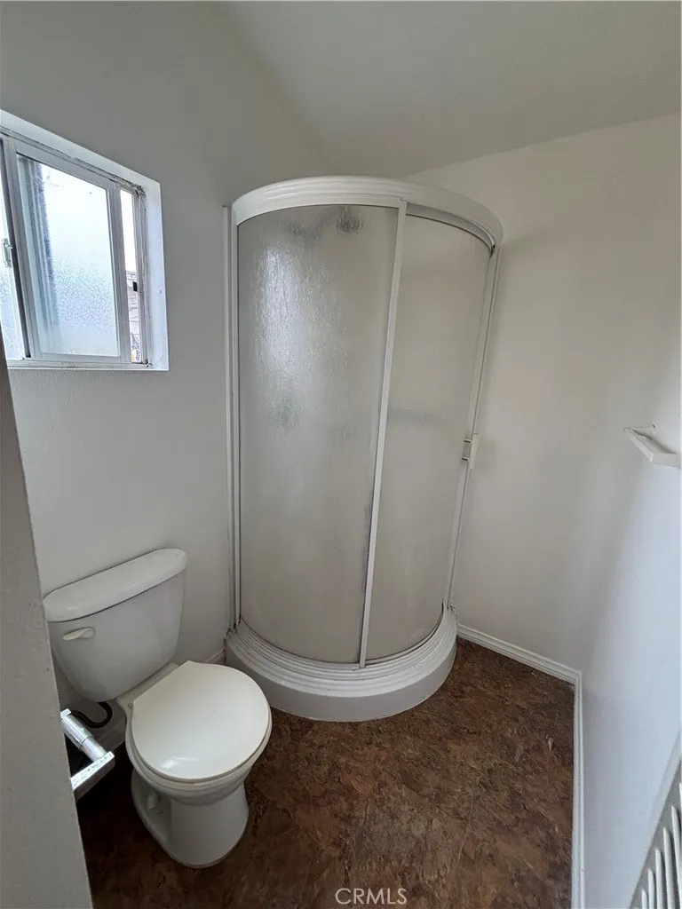 24627 Moon Avenue Lomita, CA 90717 - Photo 7 of 7 a white toilet sitting next to a shower