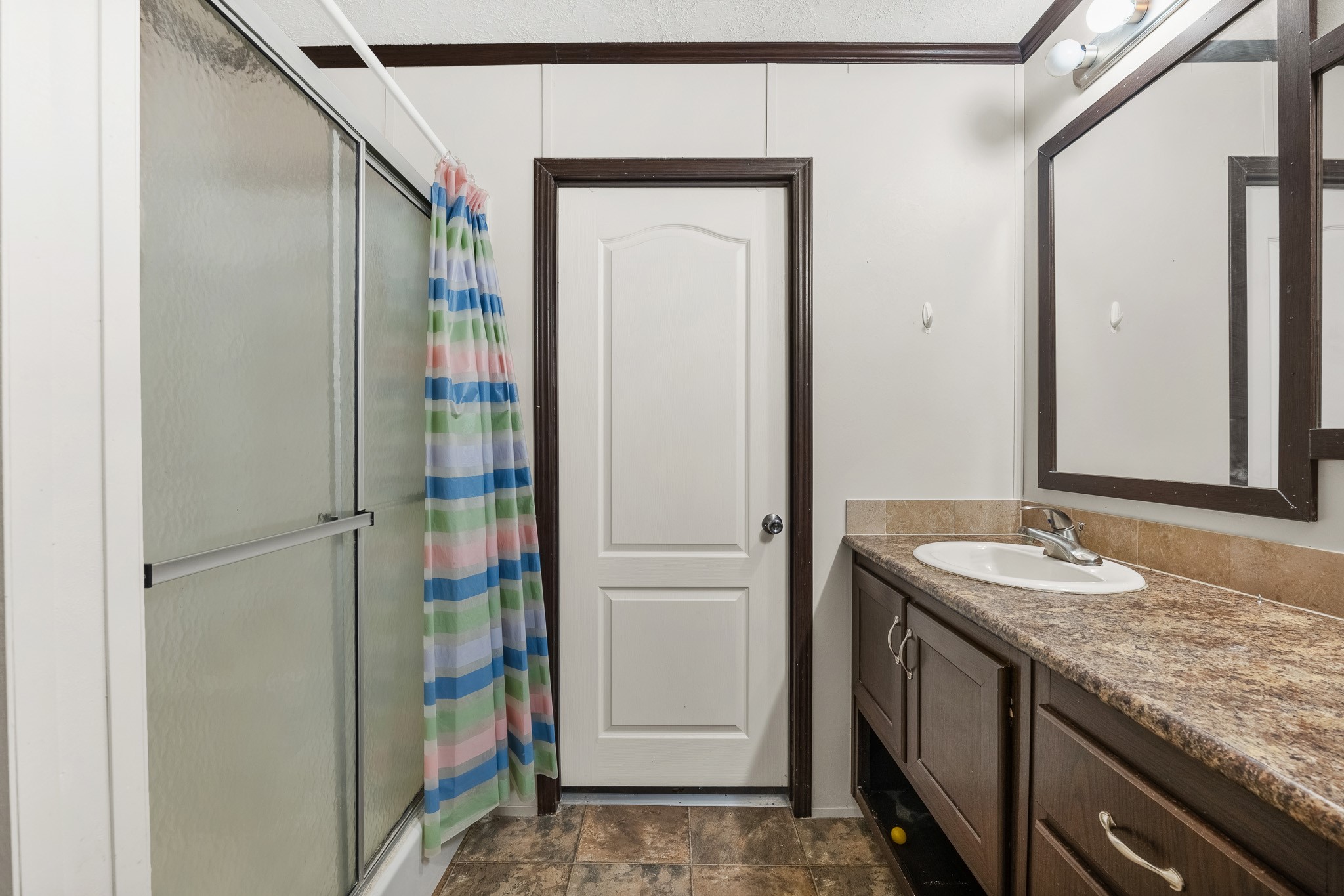 32 Oak Lake Trinity, TX 75862 - Photo 10 of 32 a bathroom with a granite countertop sink and a mirror