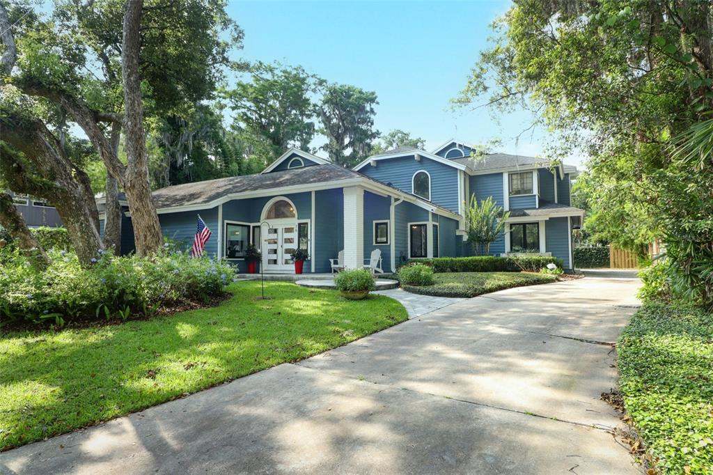 76 Eastwind Lane Maitland, FL 32751 - Photo 1 of 81 a front view of a house with a yard and potted plants
