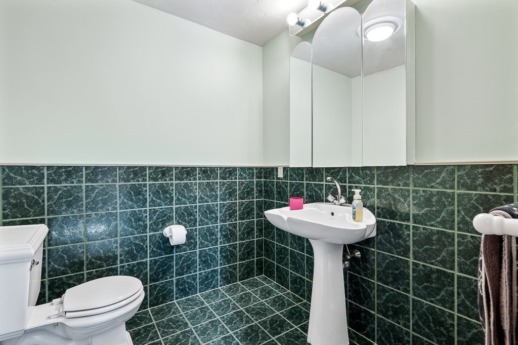 118 Upper Gore Road Webster, MA 01570 - Photo 14 of 38 a bathroom with a sink a toilet and a mirror