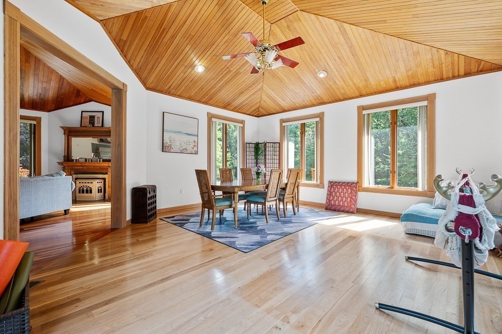 118 Upper Gore Road Webster, MA 01570 - Photo 18 of 38 a dining room with wooden floor a chandelier a glass table and chairs