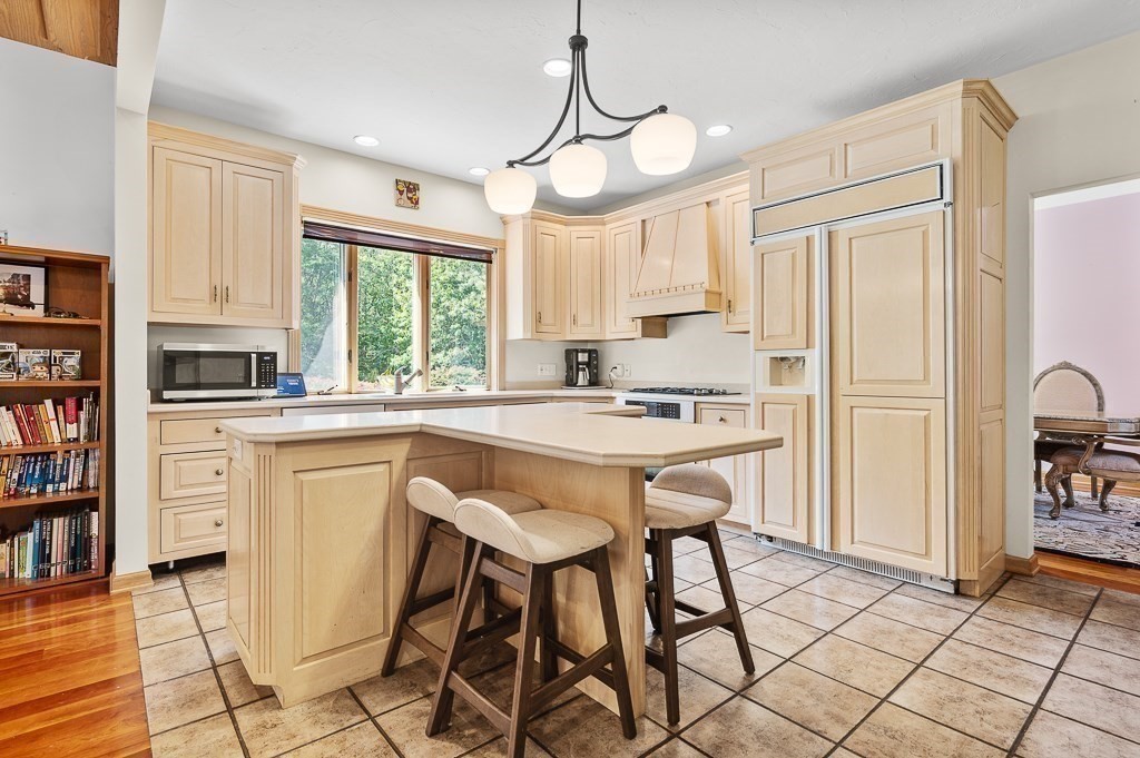 118 Upper Gore Road Webster, MA 01570 - Photo 21 of 38 a kitchen with stainless steel appliances granite countertop a stove a refrigerator a sink and white cabinets with wooden floor