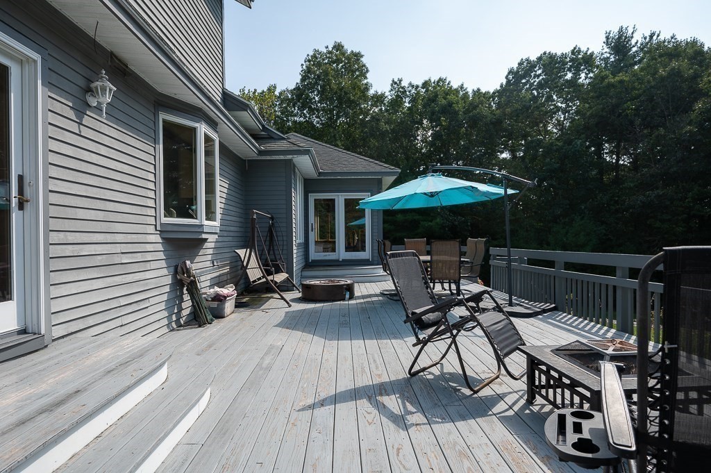 118 Upper Gore Road Webster, MA 01570 - Photo 10 of 38 a patio with wooden floor and outdoor seating
