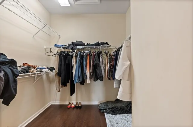a view of walk in closet with clothes and shoes
