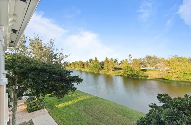 an aerial view of residential houses with outdoor space and lake view