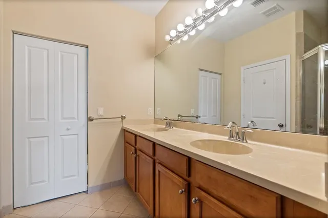 a bathroom with a double vanity sink and a mirror