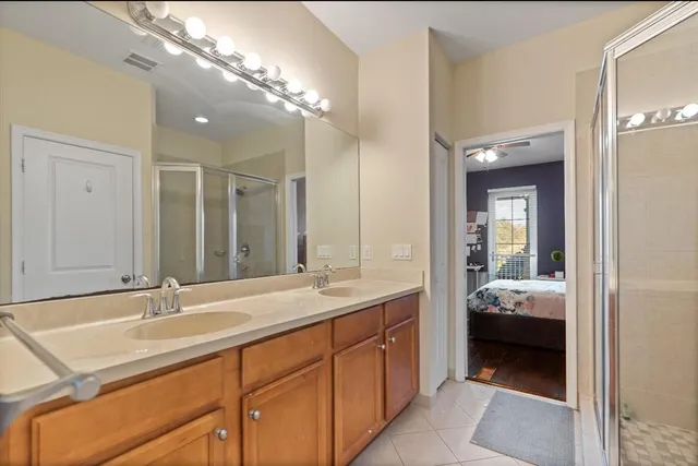 a en suite bathroom with a sink double vanity and a mirror