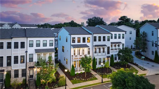 a front view of a residential apartment building with a yard