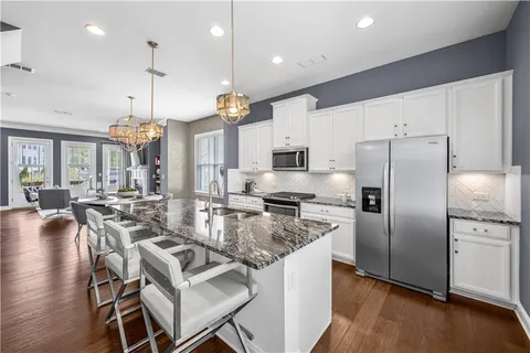 an open kitchen with a table and chairs in it