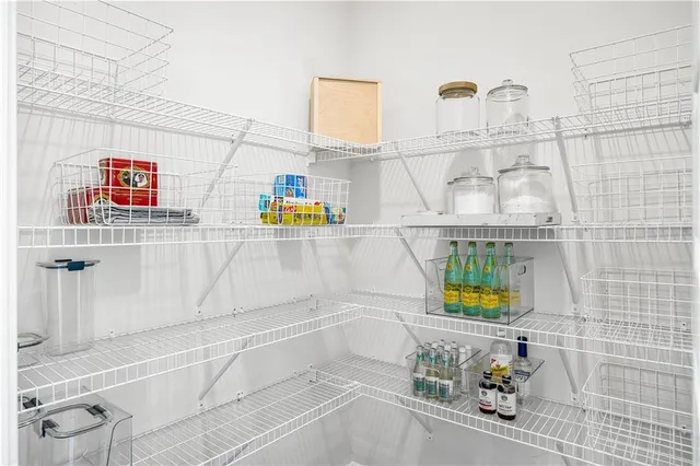a dining room with furniture potted plants and wooden floor