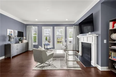 a living room with fireplace furniture and a flat screen tv