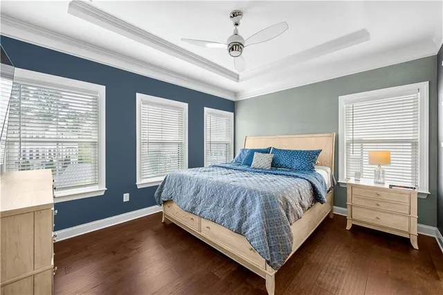 a bedroom with a large bed a chandelier and closet