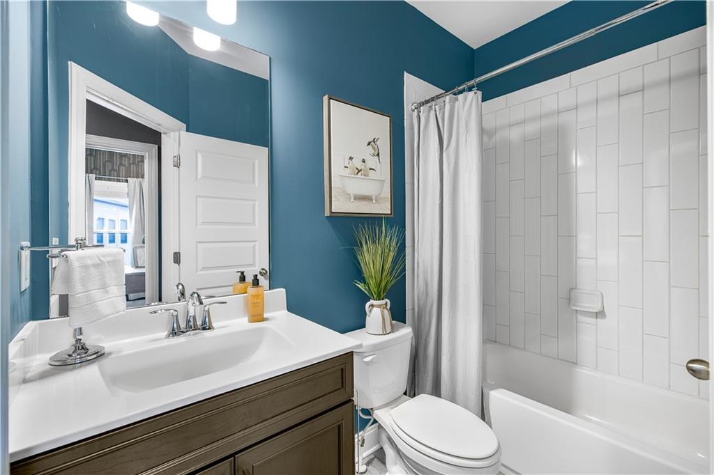 2013 Rockledge Road Northeast Atlanta, GA 30324 - Photo 32 of 50 a bathroom with a sink a toilet and shower