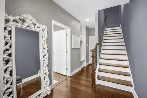 a bedroom with a large bed and windows
