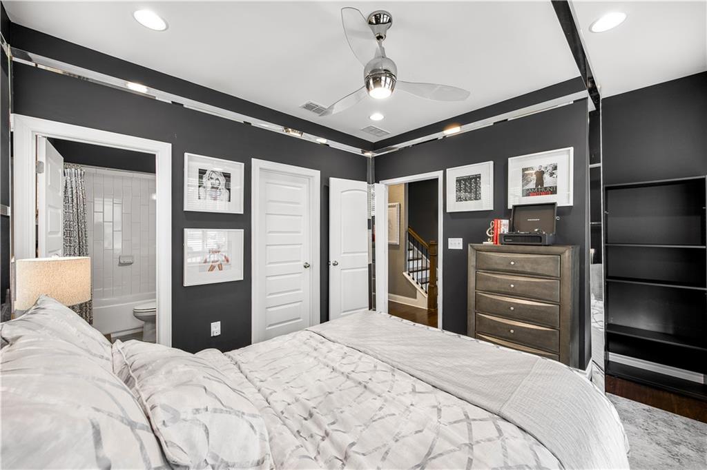 2013 Rockledge Road Northeast Atlanta, GA 30324 - Photo 41 of 50 a bedroom with a bed and closet with mirror