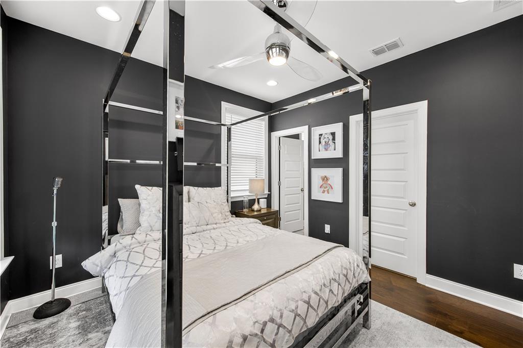 2013 Rockledge Road Northeast Atlanta, GA 30324 - Photo 42 of 50 a bedroom with a large bed and a chandelier