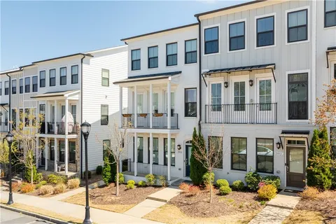 a dining room with wooden floor a chandelier a wooden table and chairs
