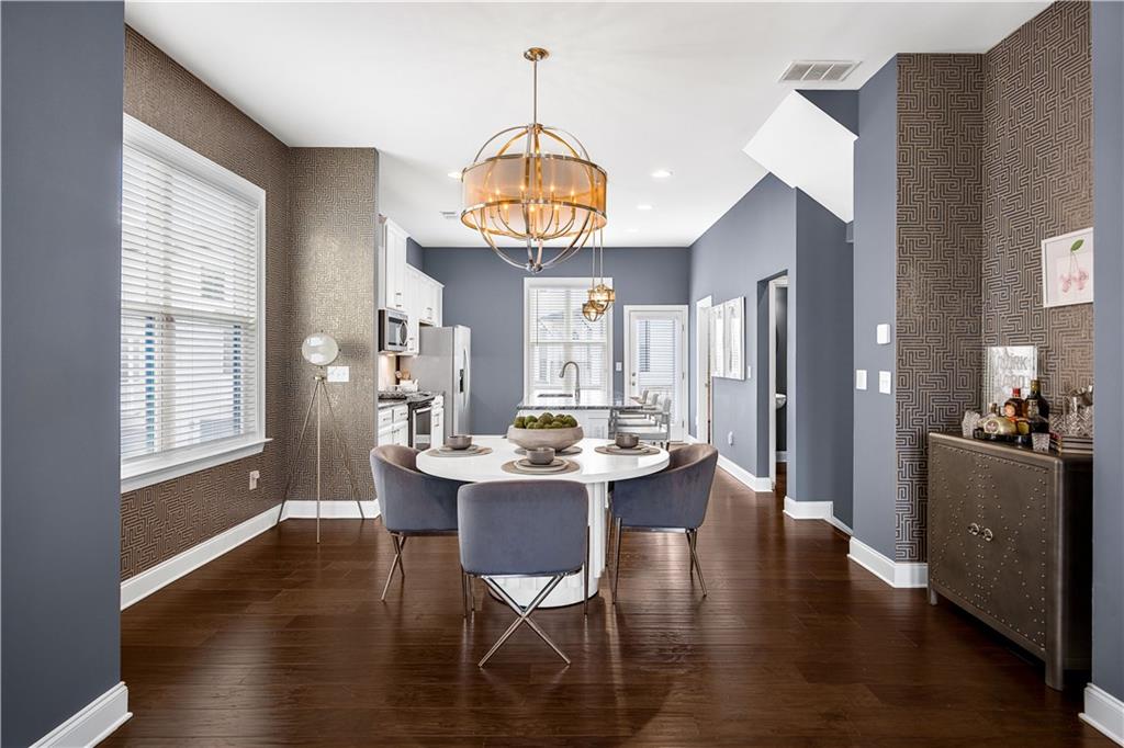 2013 Rockledge Road Northeast Atlanta, GA 30324 - Photo 6 of 50 a dining room with wooden floor a chandelier a wooden table and chairs