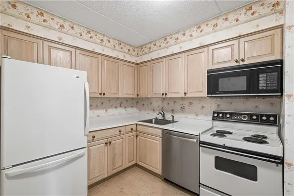 a white refrigerator freezer sitting inside of a kitchen