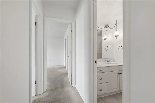 a bathroom with a granite countertop sink a toilet and shower