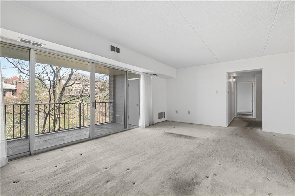 2160 Greentree Road, Unit 705W Pittsburgh, PA 15220 - Photo 6 of 32 a view of an empty room with wooden floor and a window